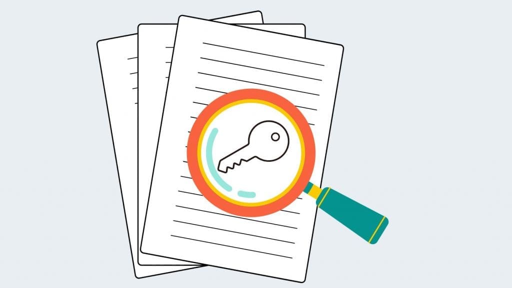 magnifying glass and a view of a key that represents keyword research when you start an online business